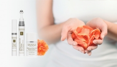 The Eminence Age Corrective Ultra Collection and a woman holding hibiscus petals in her cupped hands. 