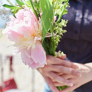 Woman holding small bouquet of wildflowers
