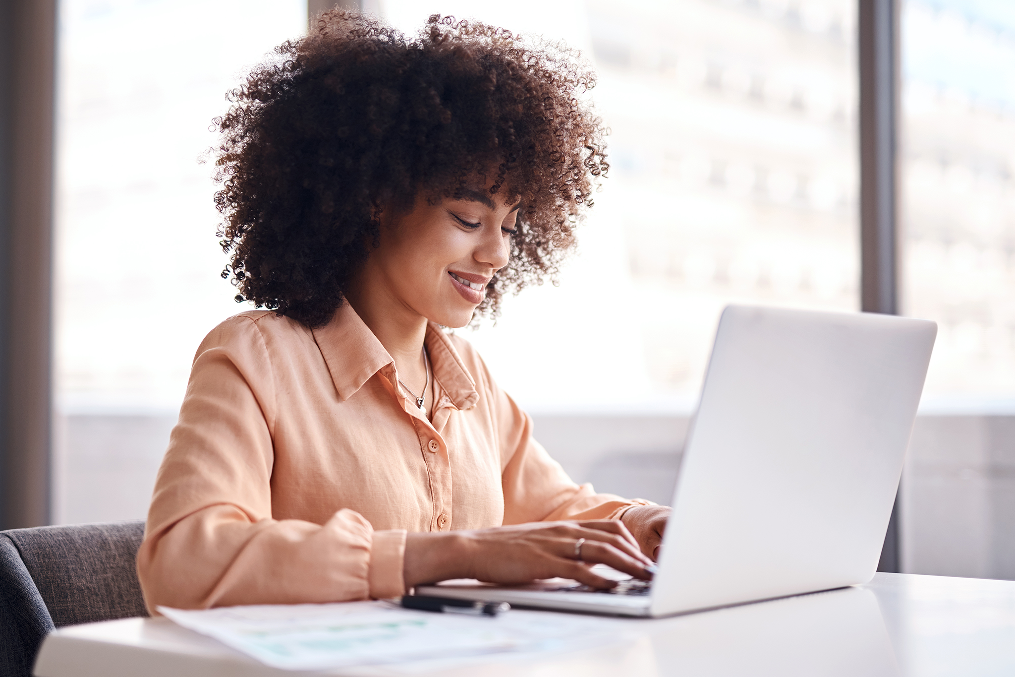 A woman in an office on her laptop