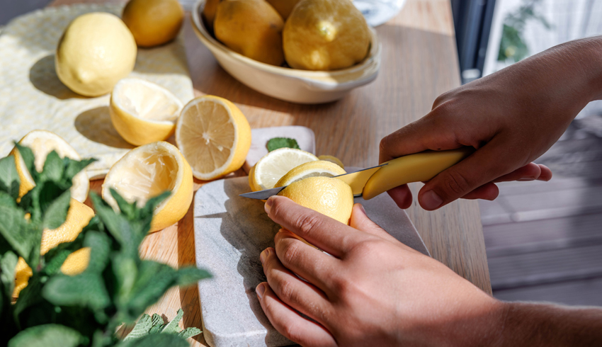 woman squeezing orange