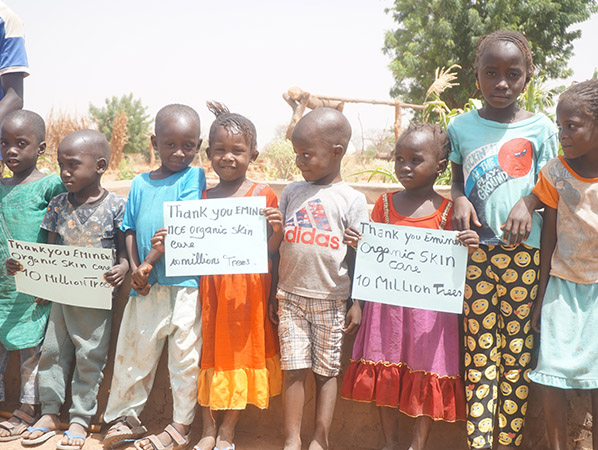 Forest Garden Project kids with 10 million trees signs