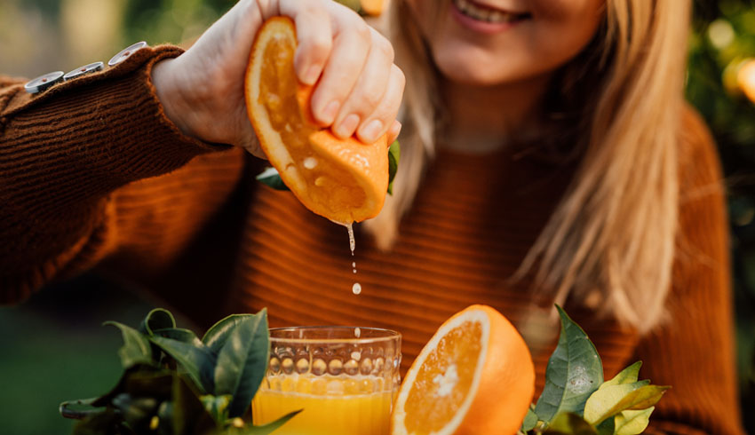 woman squeezing orange