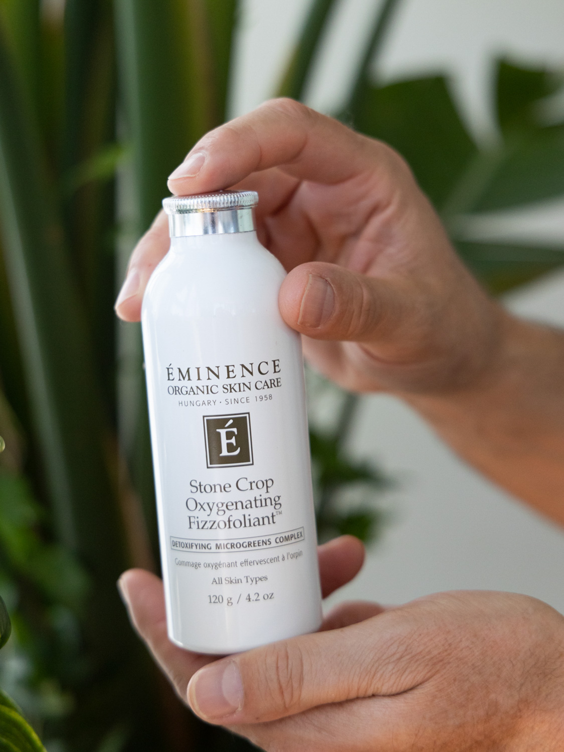 Hands holding the Eminence Organics Stone Crop Oxygenating Fizzofoliant™ 