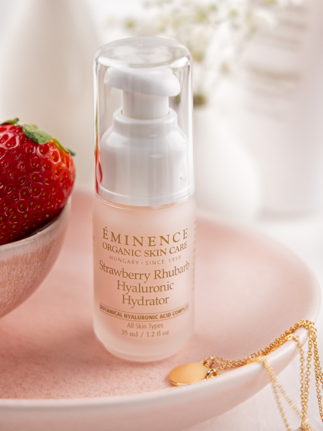 Eminence Organics Strawberry Rhubarb Hyaluronic Hydrator on a pink plate