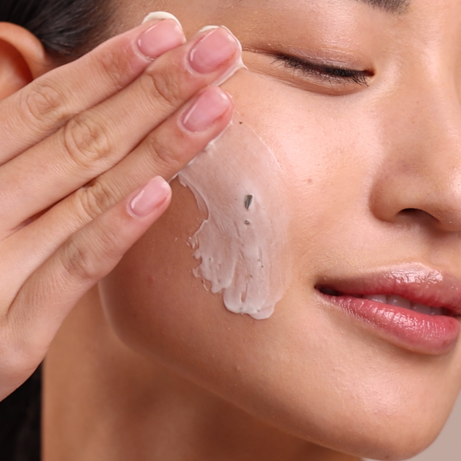 A woman applying Eminence Organics Bamboo Age Corrective Masque on face