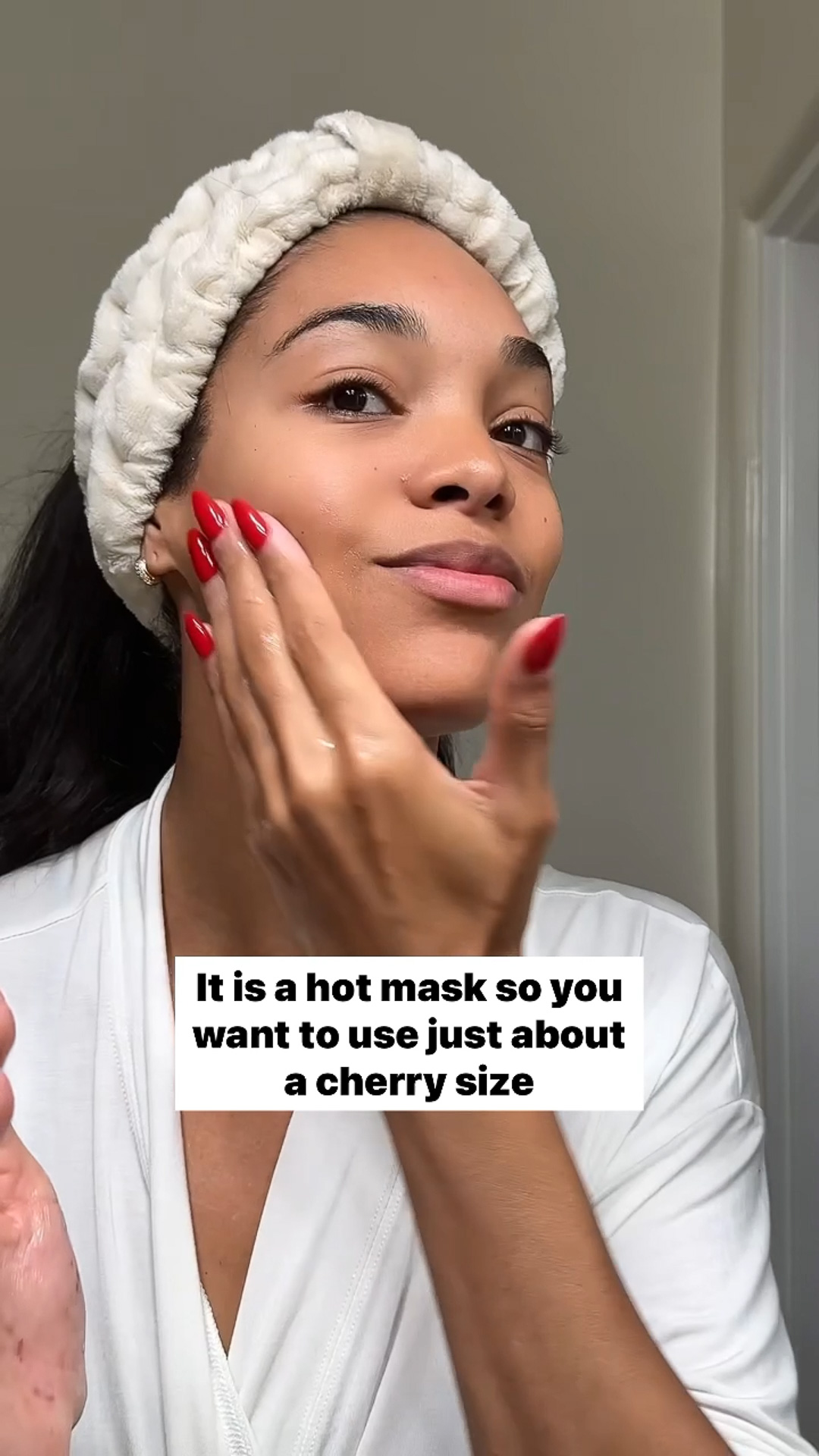 A woman applying the Eminence Organics Eight Greens Phyto Masque – Hot to her face