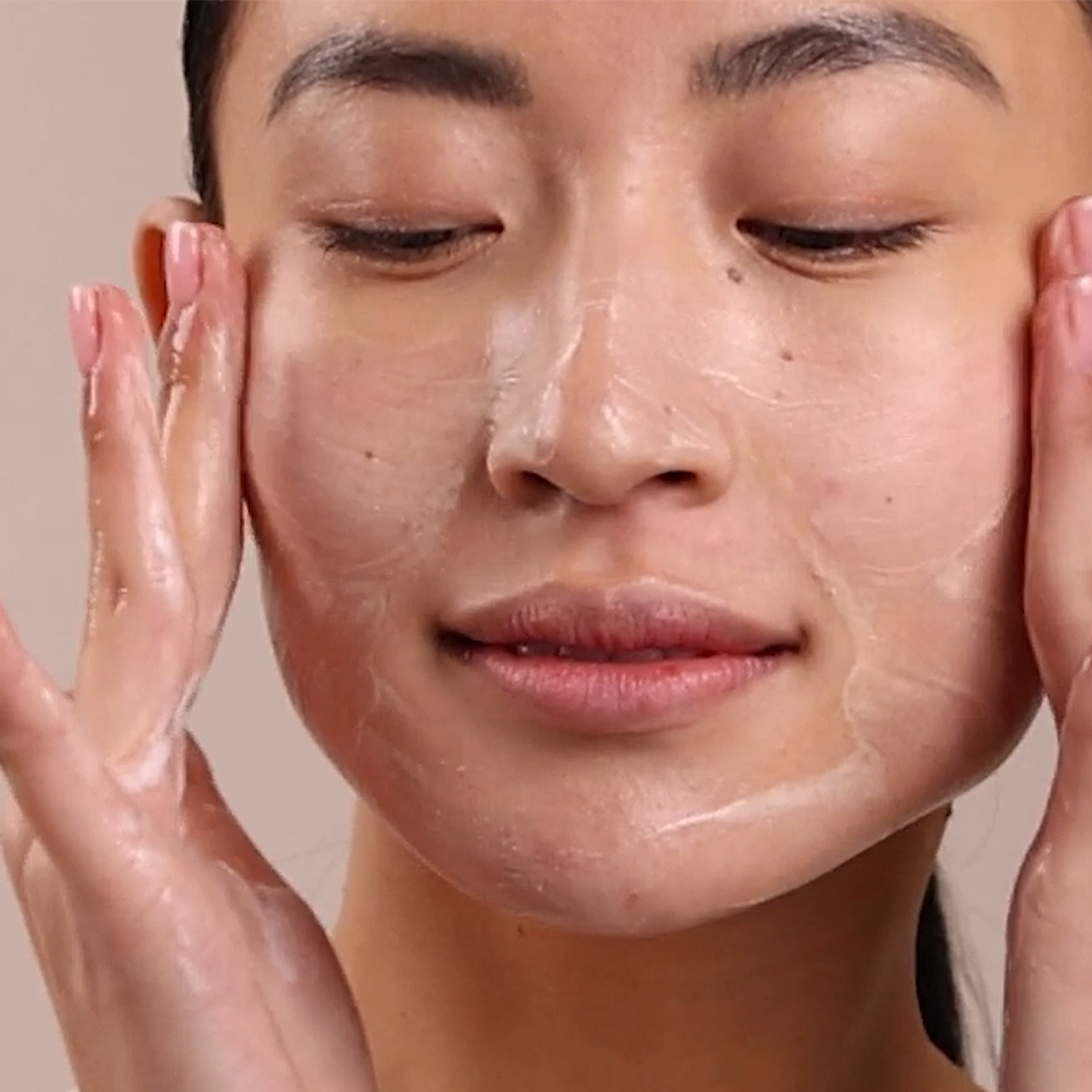 Woman applying Eminence Organics Clear Skin Probiotic Cleanser on face