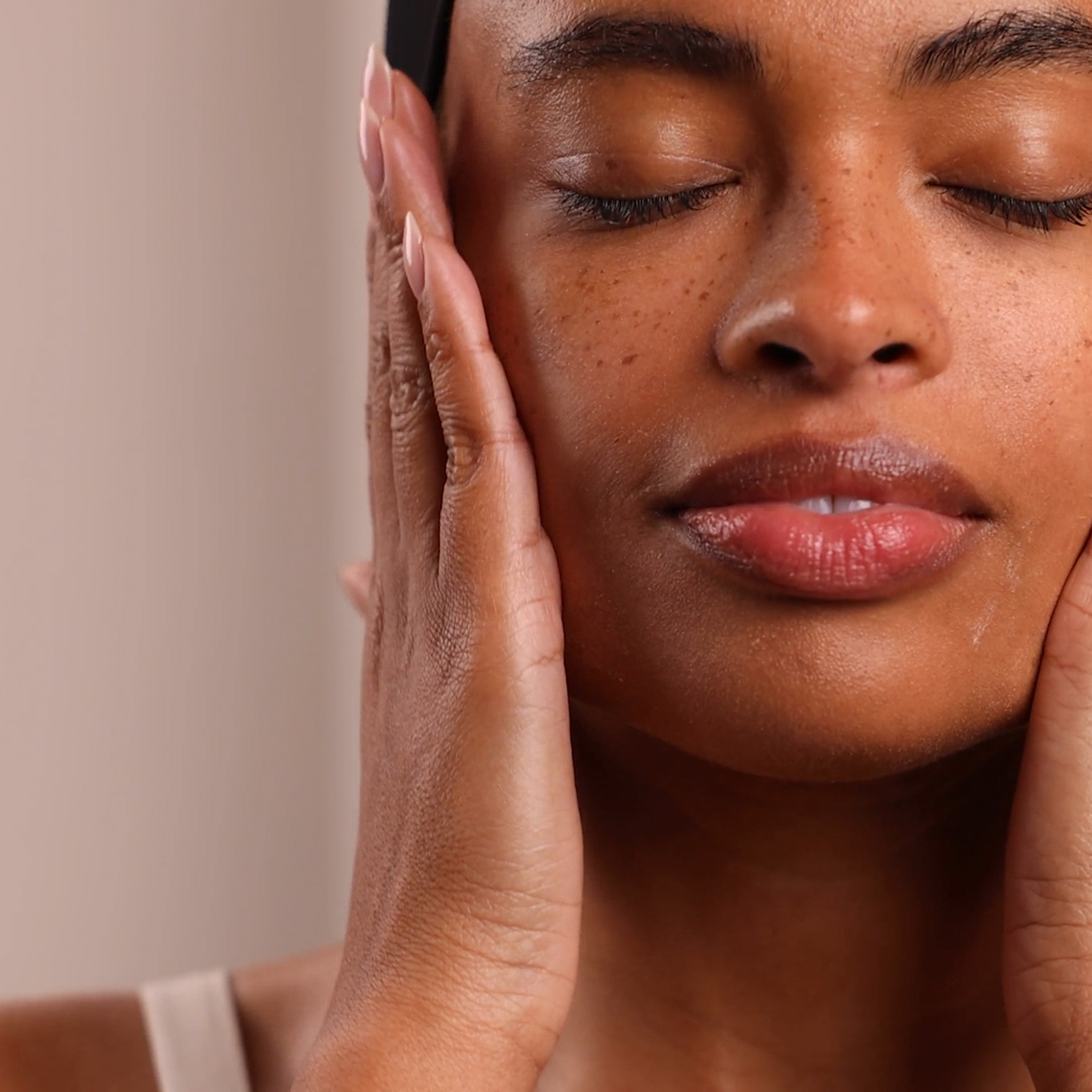 A woman applying the Eminence Organics Mangosteen Daily Resurfacing Concentrate onto their face