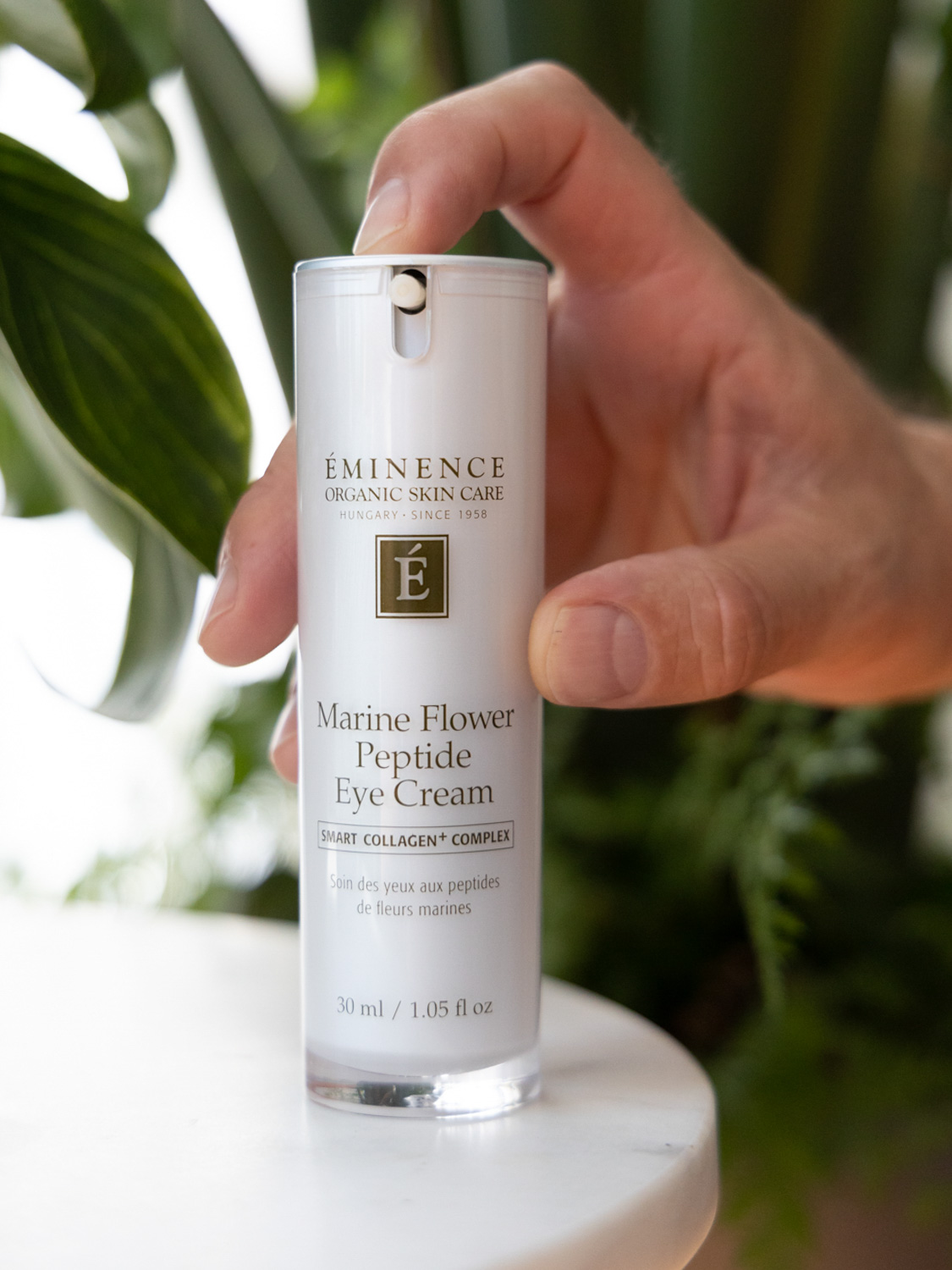 The Eminence Organics Marine Flower Peptide Eye Cream Swatch bottle on a table