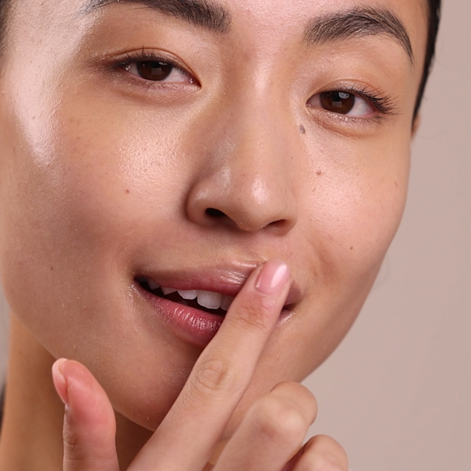 Woman applying Eminence Organics Citrus Lip Balm on lips