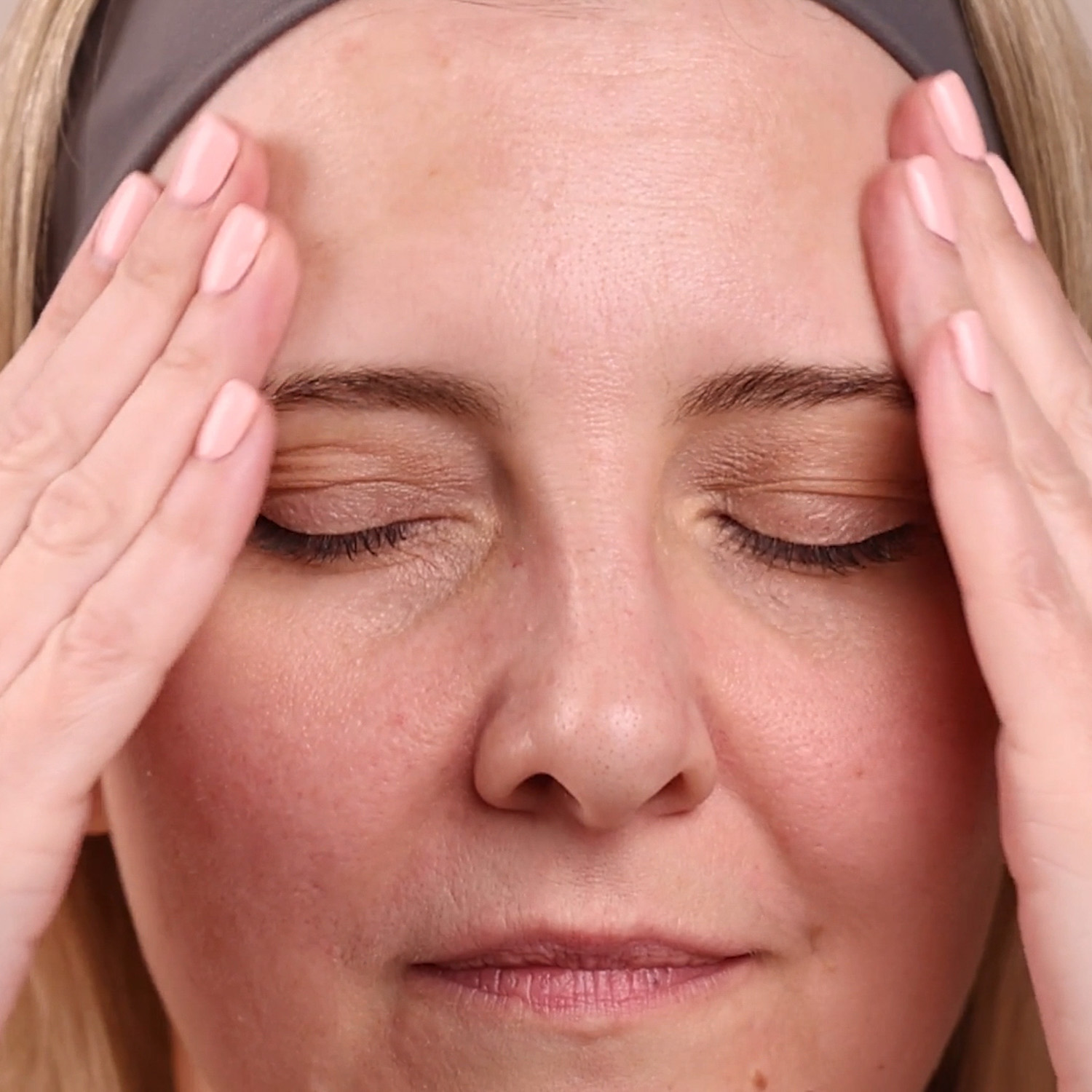 A woman applying Eminence Organics Clear Skin Bark Booster-Serum to face