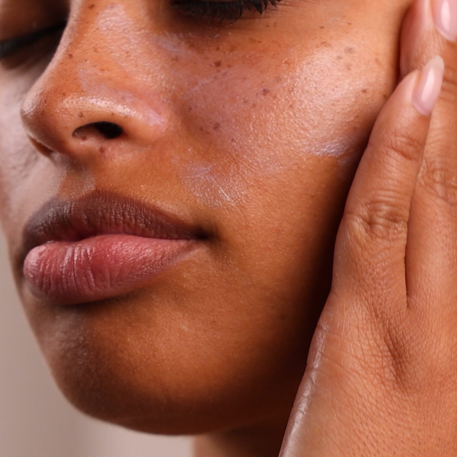 Woman applying Eminence Organics Radiant Protection SPF Fluid on her face