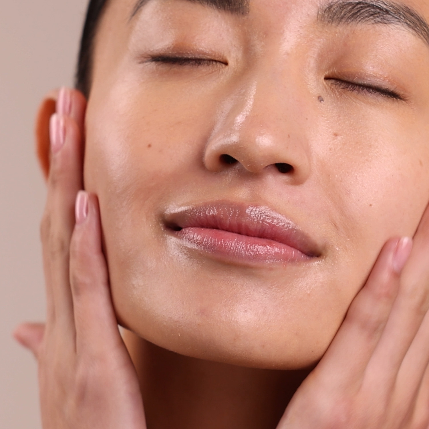 A woman applying Eminence Organics Chamomile Moisturizer to face