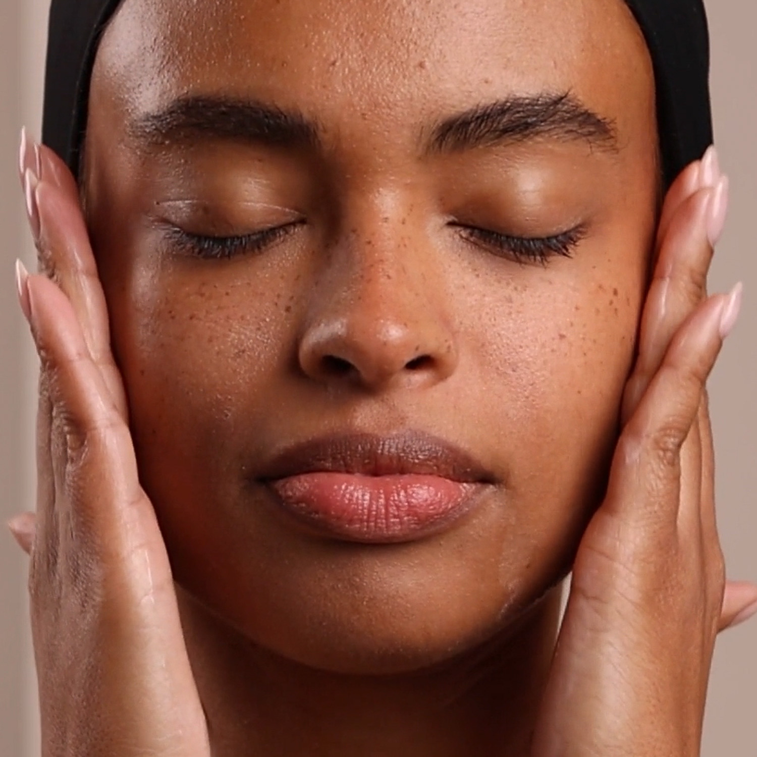 A woman applying Eminence Organics Clear Skin Probiotic Moisturizer to face
