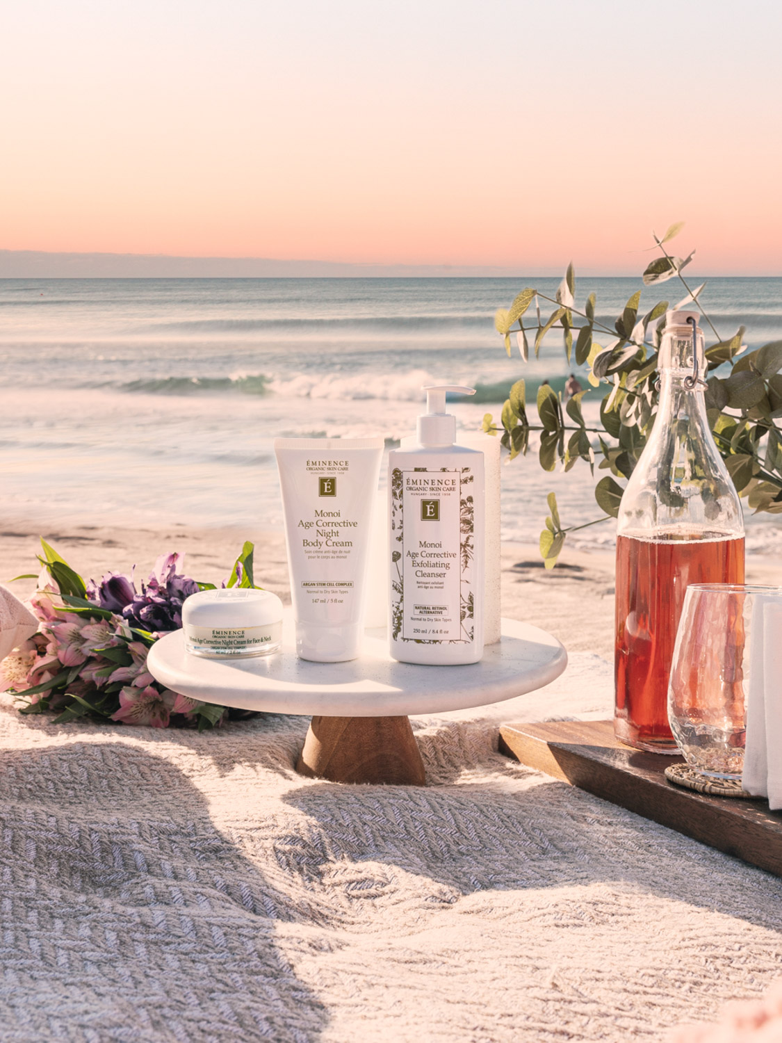 The Eminence Organics Monoi Age Corrective Collection on the beach