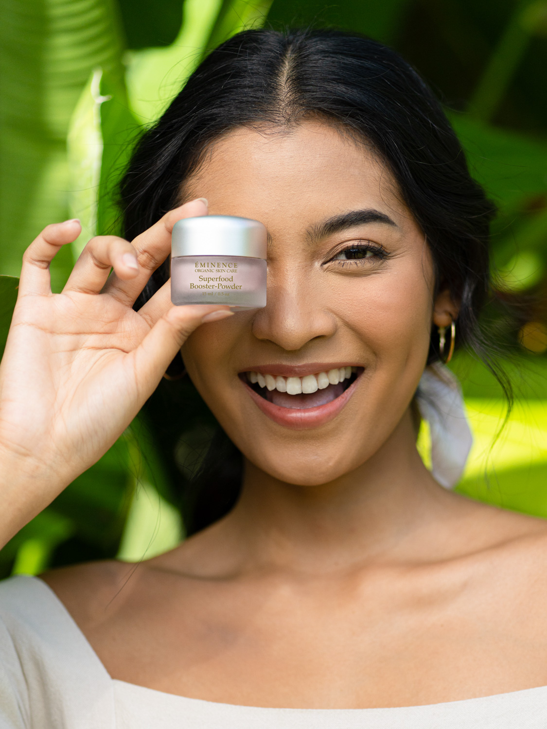 A woman holding the Eminence Organics Superfood Booster-Powder