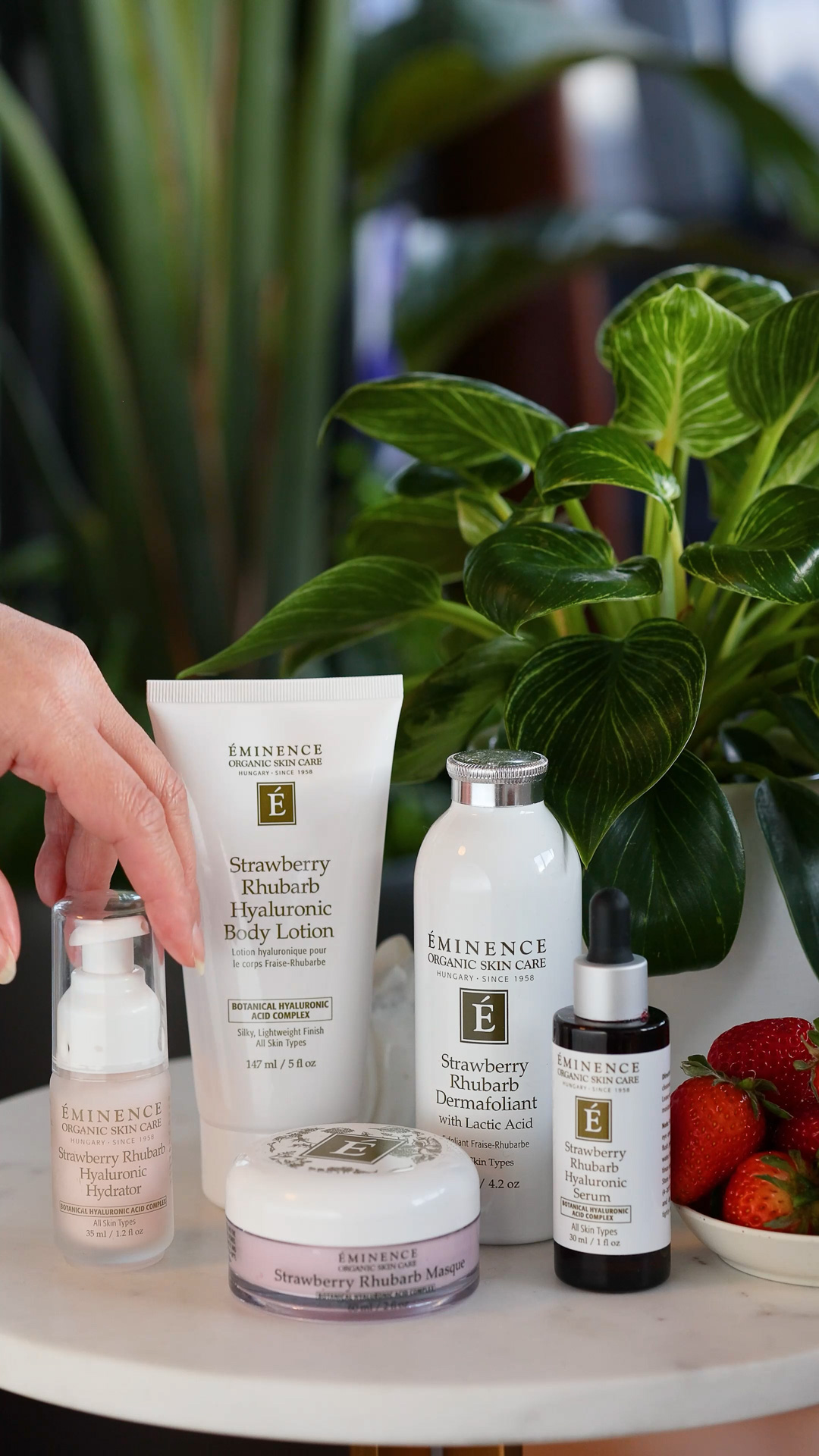 Eminence Organics Strawberry Rhubarb Collection with a green outdoors background