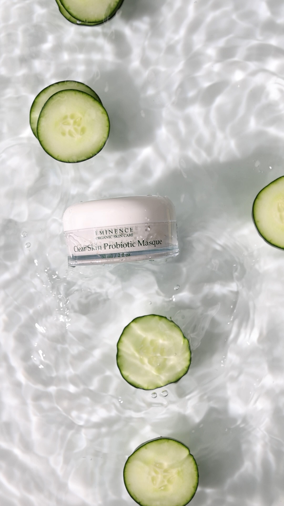 A woman applying Eminence Organics Clear Skin Probiotic Masque on face outside