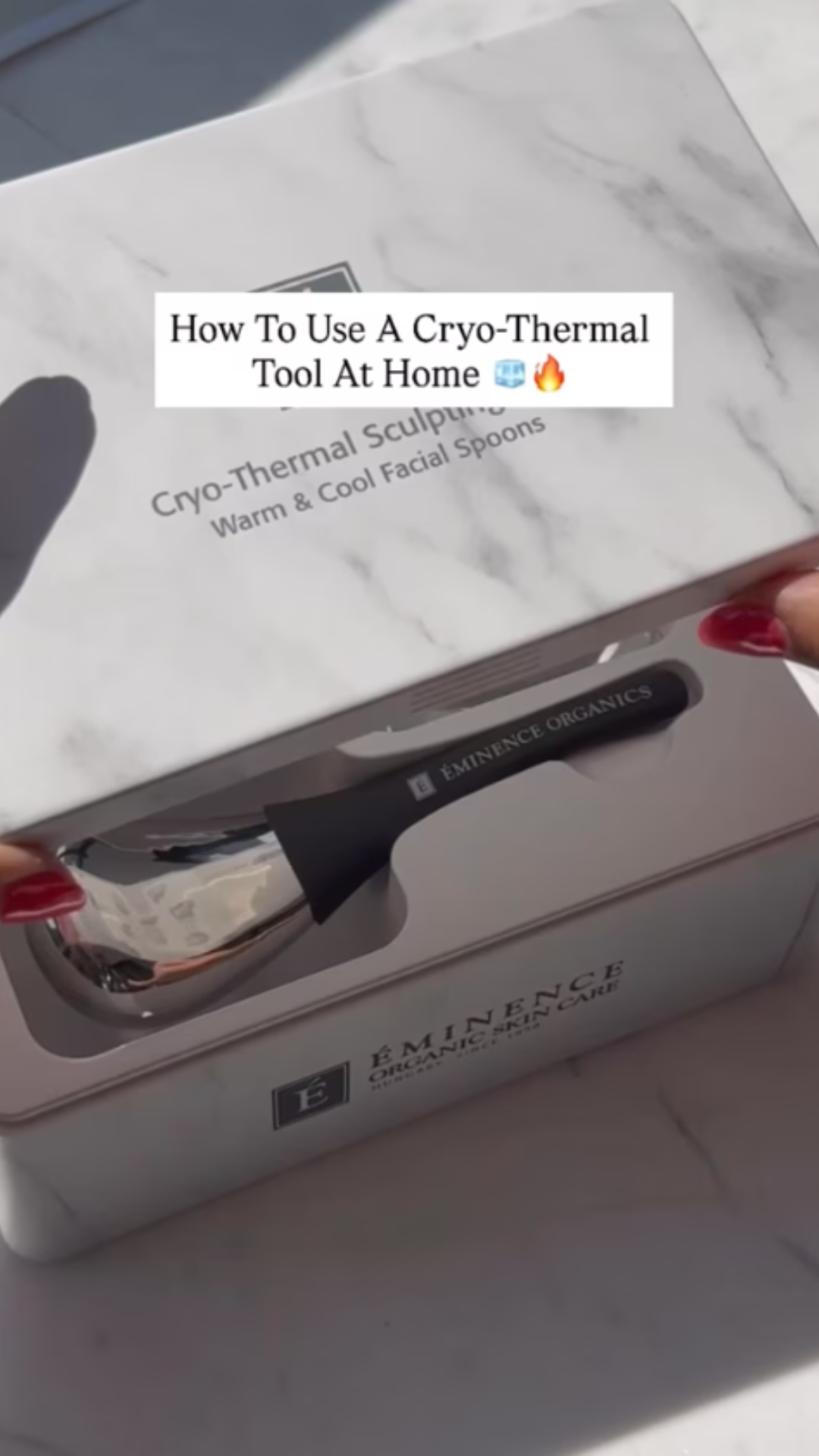 A woman opening the Eminence Organics Cryo-Thermal Sculpting Tool box