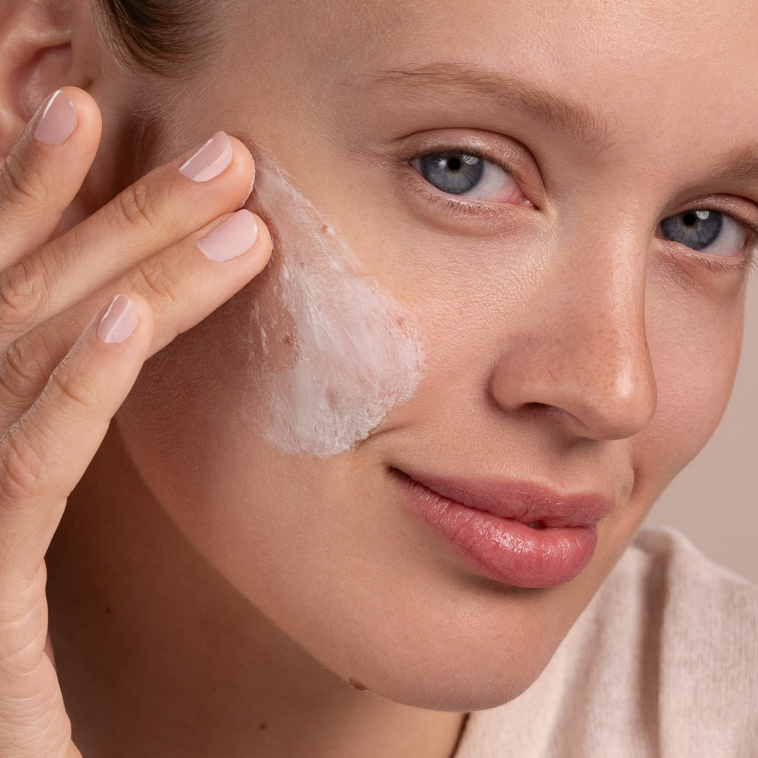 A woman with a swatch of the Eminence Organics Snow Mushroom & Reishi Masque on her face