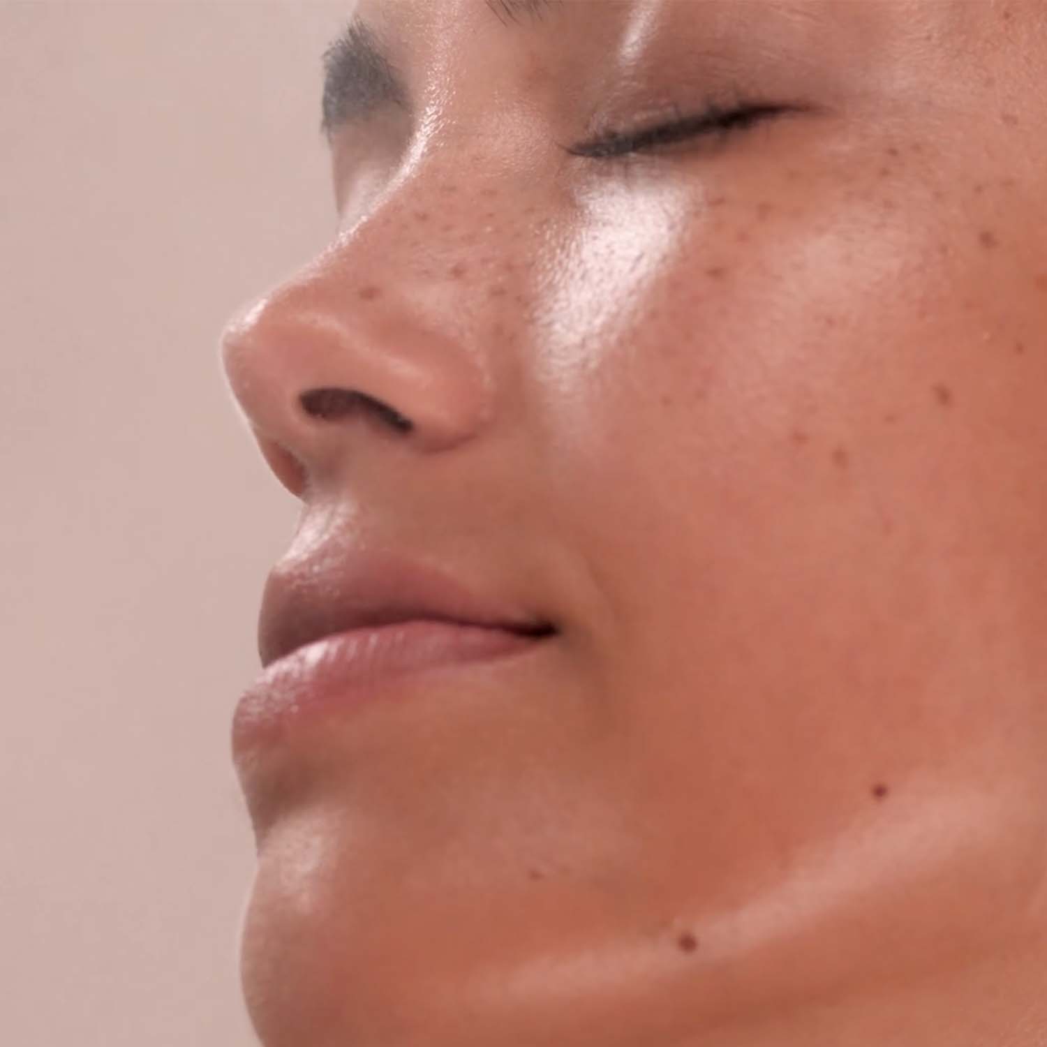 A woman applying Eminence Organics Shiitake & Ashwagandha Bi-Phase Mist to her face