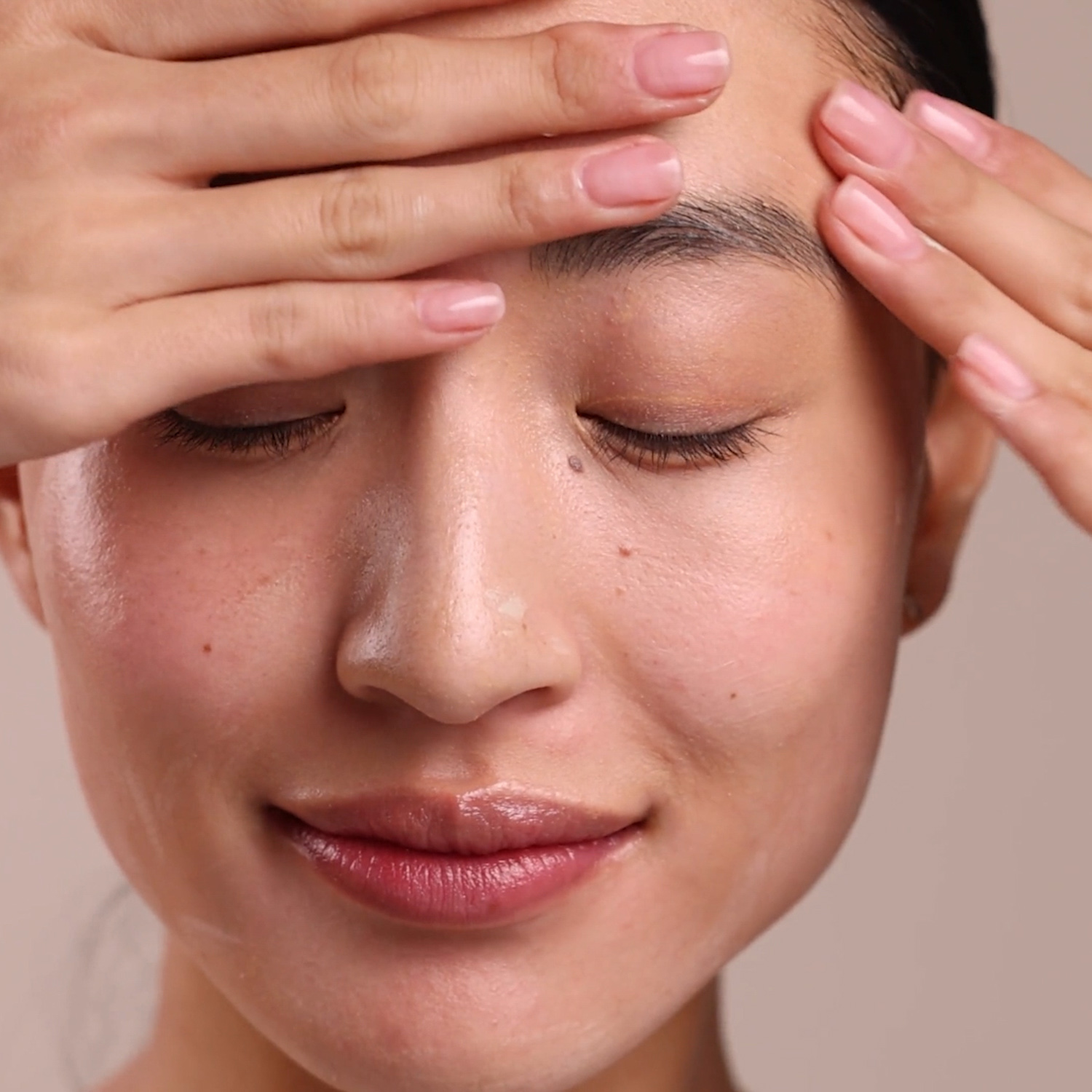 A woman applying the Eminence Organics Stone Crop Whip Moisturizer on her face