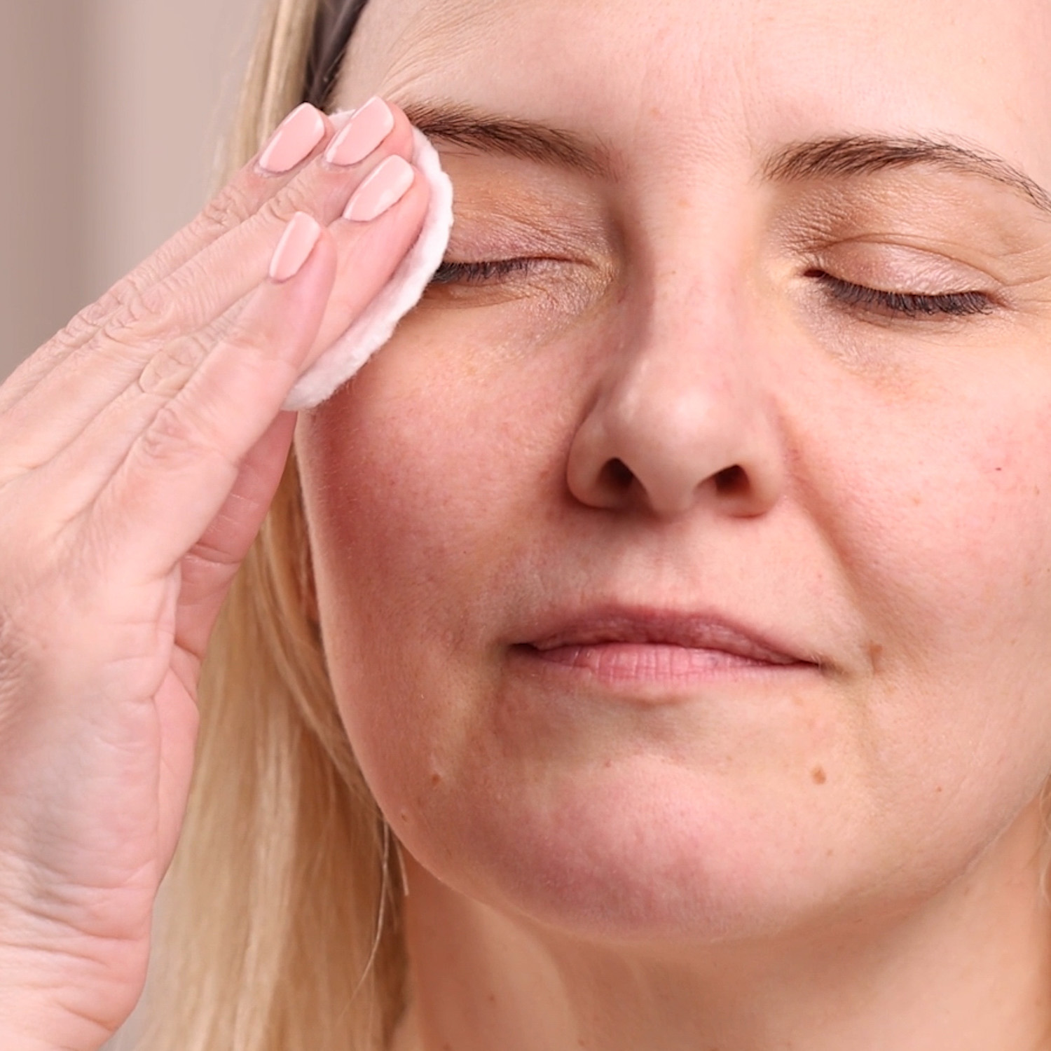 A woman removing her make-up with the Eminence Organics Herbal Eye Make-up Remover