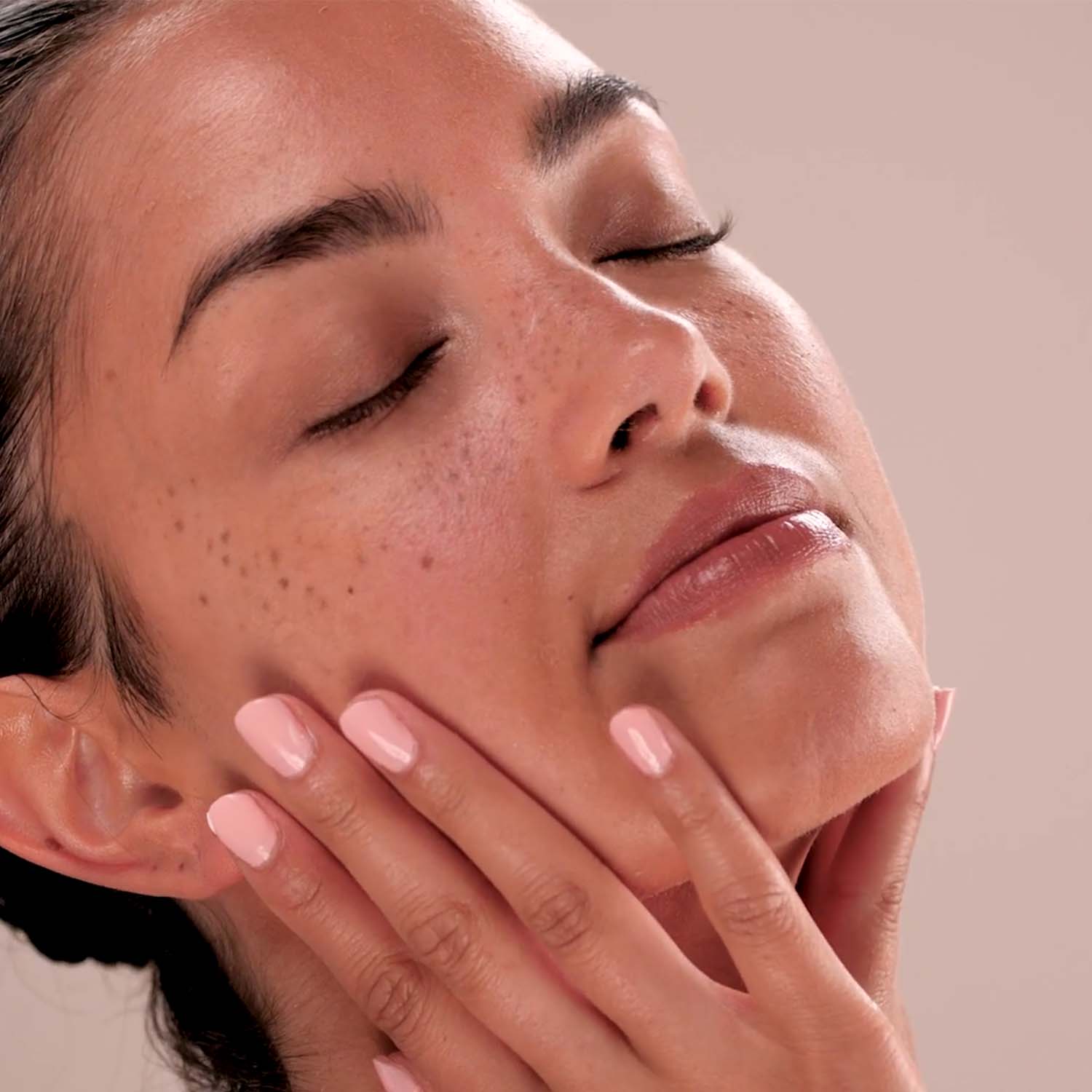 A woman applying the Eminence Organics Ashwagandha Ultra-Rich Restorative Cream 