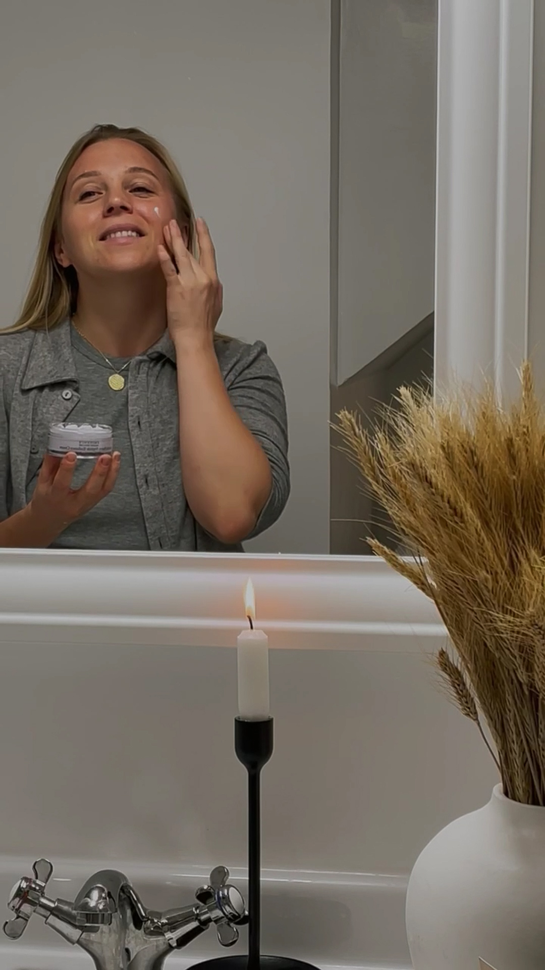 A woman applying Eminence Organics Arctic Berry Radiance Cream to face