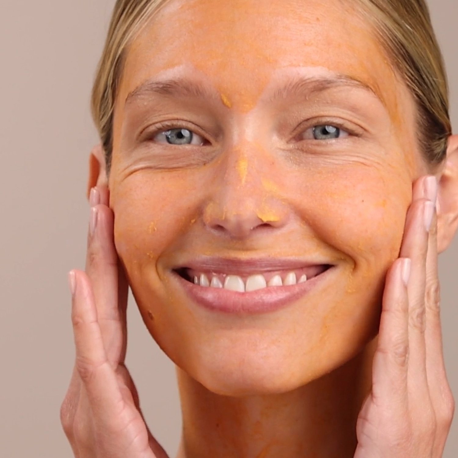 A woman with the Eminence Organics Yam & Pumpkin Enzyme Peel 5% applied on to her face