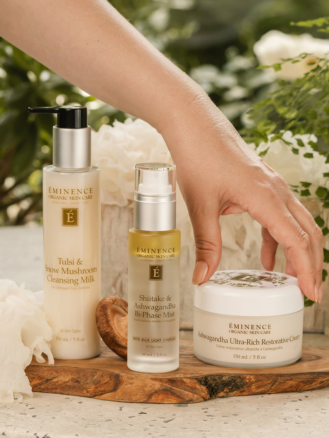 A woman reaching for the Eminence Organics Ashwagandha Ultra-Rich Restorative Cream 