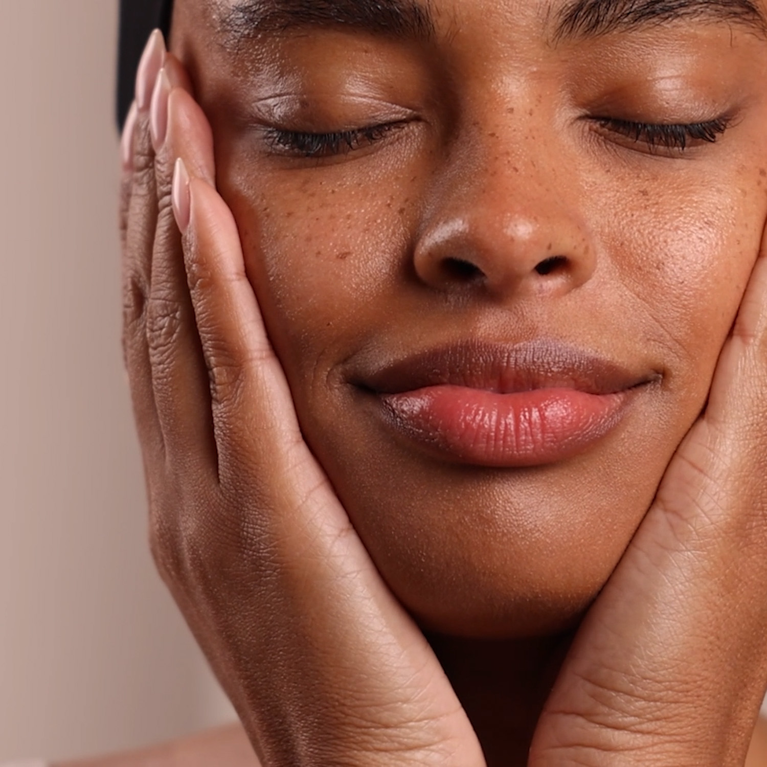A woman applying Eminence Organics Birch Water Purifying Essence to face
