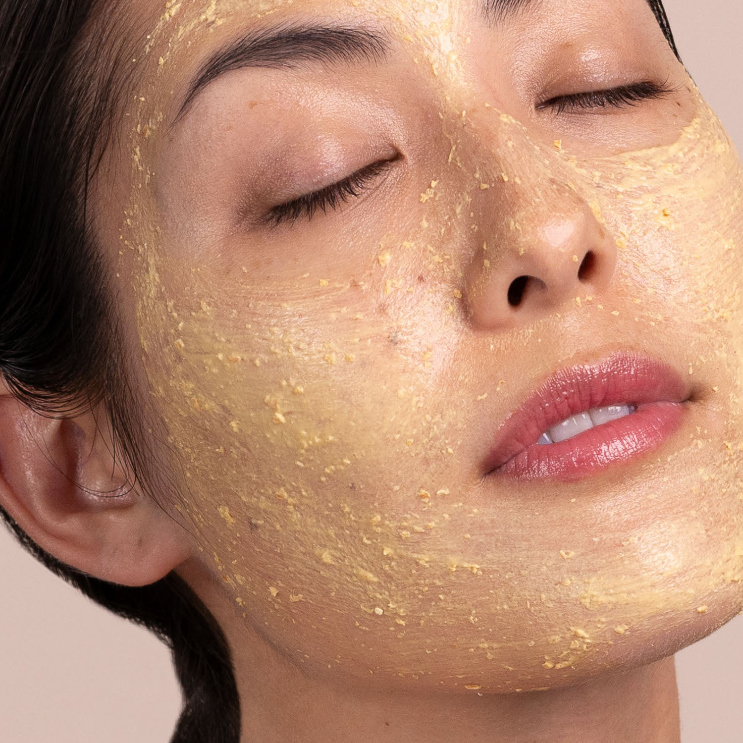 A woman with a swatch of the Eminence Organics Seabuckthorn Balancing Masque on her face