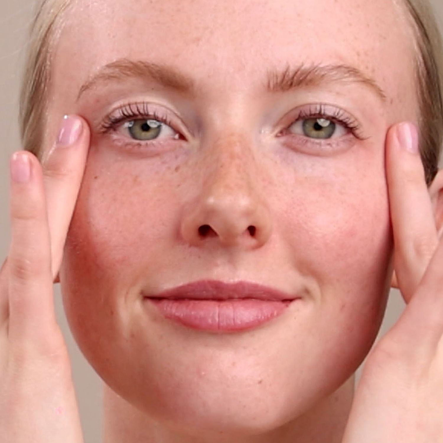 A woman applying the Eminence Organics Snow Mushroom Moisture Cloud Eye Cream under her eyes