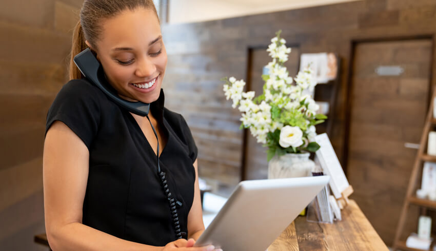 Woman on the phone and using the ipad