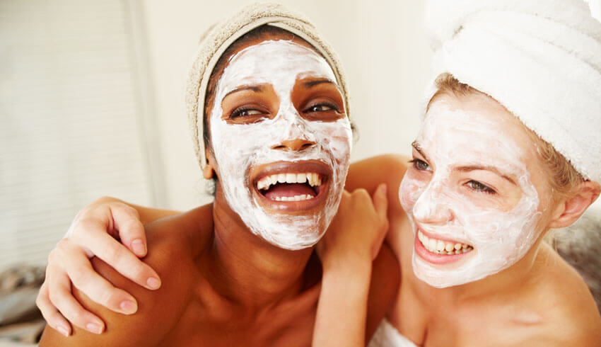 Two women with facial masks on