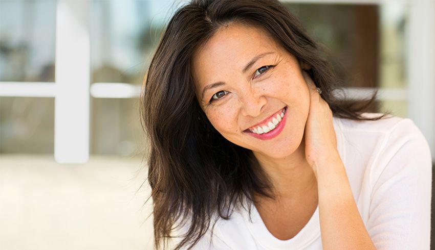 Woman smiling with clear skin and small pores