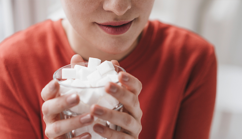 woman holding a cup of sugar cubes