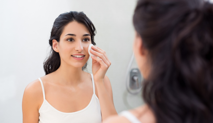 a woman with a cotton pad