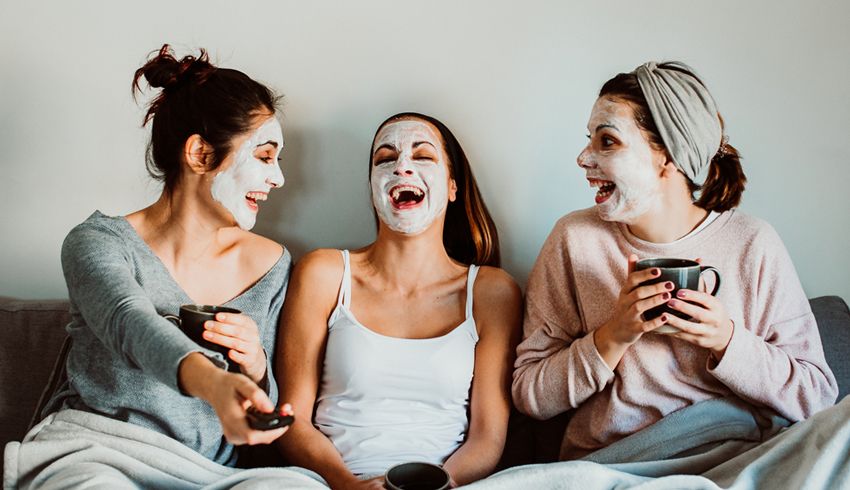 women in overnight face masks laughing