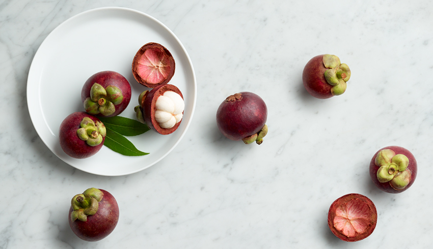 Mangosteens on a plate and marble counter