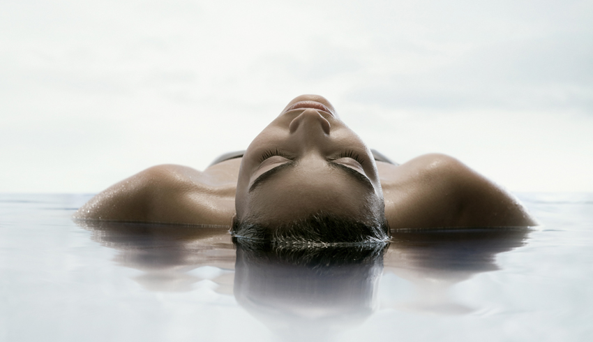 Woman floating in water at the spa