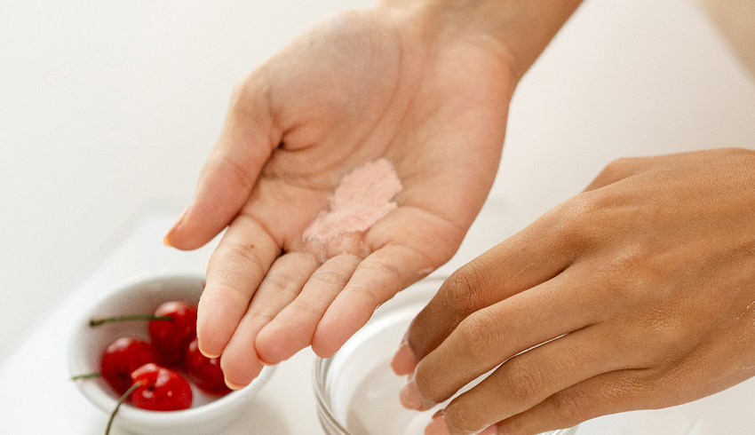 a woman with an exfoliating powder in her hand