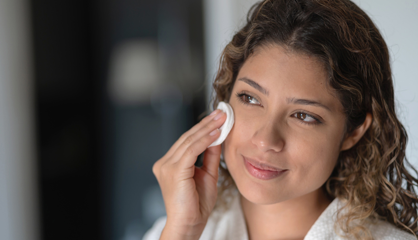 a woman with a cotton pad