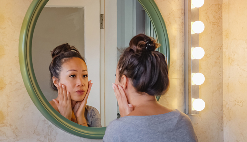 A woman staring in the mirror