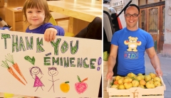 Two photos: (1) A young child holding a hand-drawn sign with Thank-you Eminence! Written in bold letters across and illustrated with two children surrounded by carrots, an apple and an orange, and (2) a photo of Eminence Organics President Boldijarre Koronczay holding a wooden crate brimming with pears on their way to being donated as part of the Eminence Kids Foundation. 