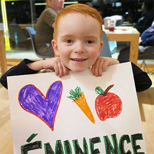 Eminence Kids Foundation child holding up sign
