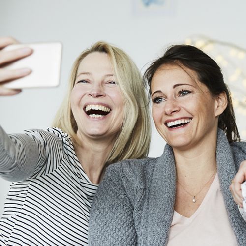 two women in 40s taking selfie