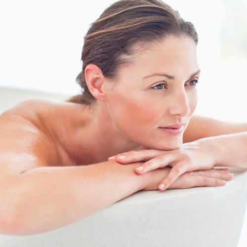 Woman relaxing in bath tub